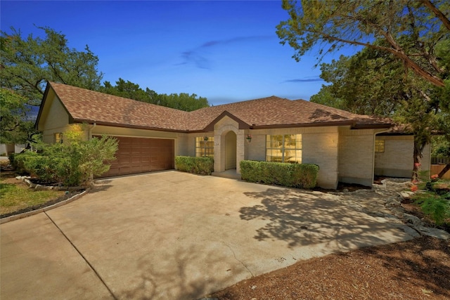 314 Hurst Creek Rd, Lakeway, TX 78734 - ranch-style house with a garage, concrete driveway, brick siding, and a shingled roof