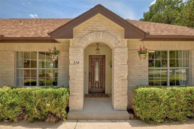 314 Hurst Creek Rd, Lakeway, TX 78734 - entrance to property with a shingled roof and brick siding