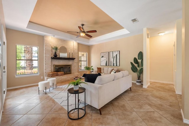 314 Hurst Creek Rd, Lakeway, TX 78734 - living area with a tray ceiling, ceiling fan, light tile patterned floors, and a fireplace