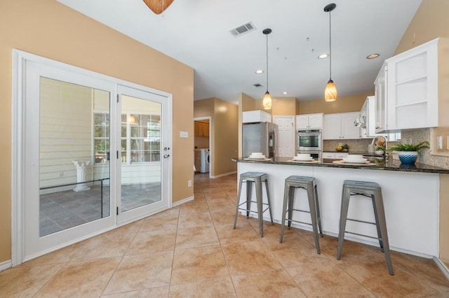 314 Hurst Creek Rd, Lakeway, TX 78734 - kitchen with appliances with stainless steel finishes, a peninsula, dark countertops, open shelves, and white cabinets