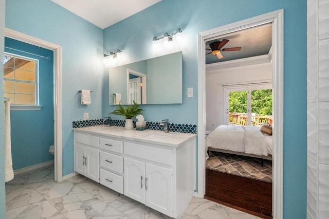 314 Hurst Creek Rd, Lakeway, TX 78734 - ensuite bathroom with marble look tile flooring, double vanity, ceiling fan, and toilet