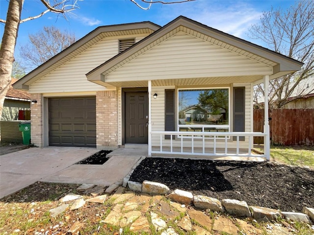2603 Tracy Trl, Austin, TX 78728 - view of front of property featuring covered porch, driveway, an attached garage, and brick siding