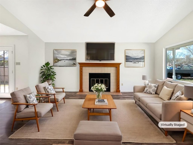 2603 Tracy Trl, Austin, TX 78728 - living room featuring vaulted ceiling, healthy amount of natural light, a ceiling fan, wood finished floors, and a tile fireplace