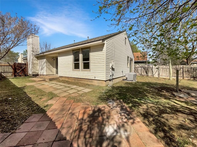 2603 Tracy Trl, Austin, TX 78728 - rear view of property featuring a fenced backyard, a patio area, and a chimney