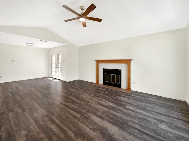 2603 Tracy Trl, Austin, TX 78728 - unfurnished living room with a ceiling fan, lofted ceiling, dark wood-type flooring, and a tiled fireplace