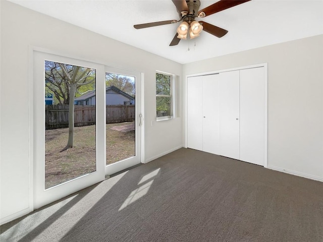 2603 Tracy Trl, Austin, TX 78728 - unfurnished bedroom with access to exterior, dark colored carpet, ceiling fan, and a closet
