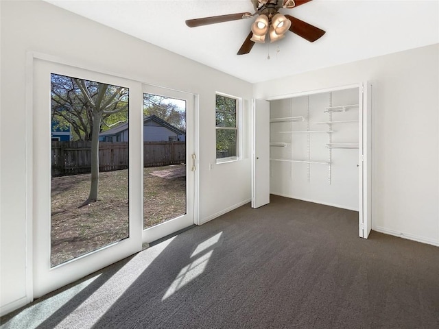 2603 Tracy Trl, Austin, TX 78728 - unfurnished bedroom featuring multiple windows, dark colored carpet, a ceiling fan, and access to outside