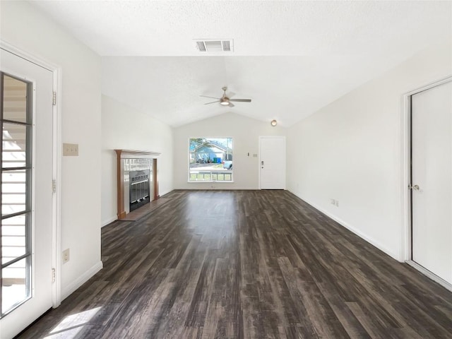 2603 Tracy Trl, Austin, TX 78728 - unfurnished living room with a ceiling fan, dark wood finished floors, lofted ceiling, and a tiled fireplace