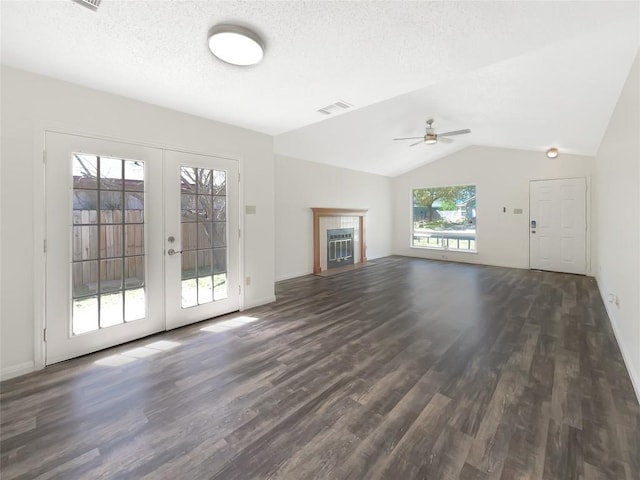 2603 Tracy Trl, Austin, TX 78728 - unfurnished living room with ceiling fan, dark wood-style flooring, lofted ceiling, french doors, and a textured ceiling