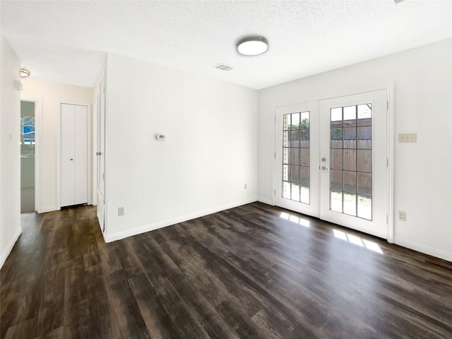 2603 Tracy Trl, Austin, TX 78728 - empty room with dark wood-style flooring, french doors, and a textured ceiling
