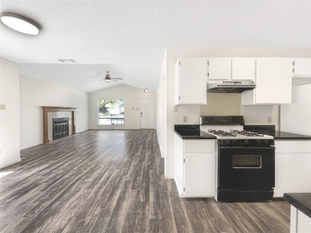 2603 Tracy Trl, Austin, TX 78728 - kitchen featuring black gas range, under cabinet range hood, ceiling fan, dark wood finished floors, and dark countertops