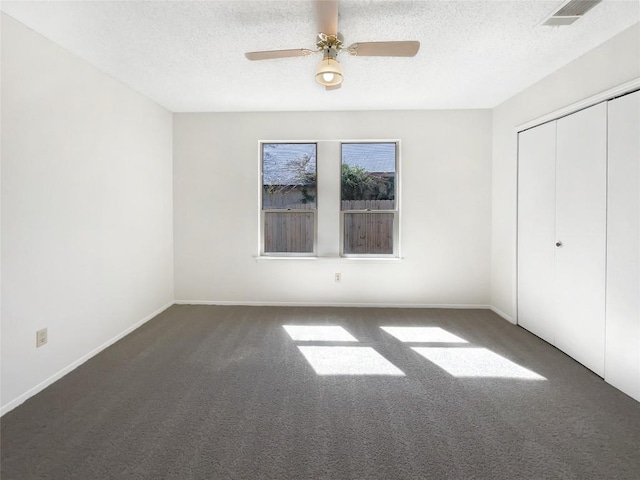 2603 Tracy Trl, Austin, TX 78728 - unfurnished bedroom with carpet flooring, a closet, a textured ceiling, and a ceiling fan