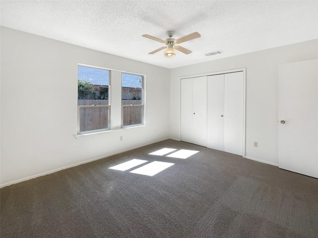 2603 Tracy Trl, Austin, TX 78728 - unfurnished bedroom featuring carpet, a textured ceiling, a ceiling fan, and a closet