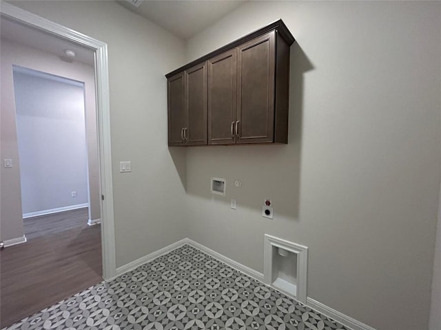 8217 Grenadier Dr, Austin, TX 78738 - laundry area with electric dryer hookup, washer hookup, cabinet space, dark floors, and gas dryer hookup