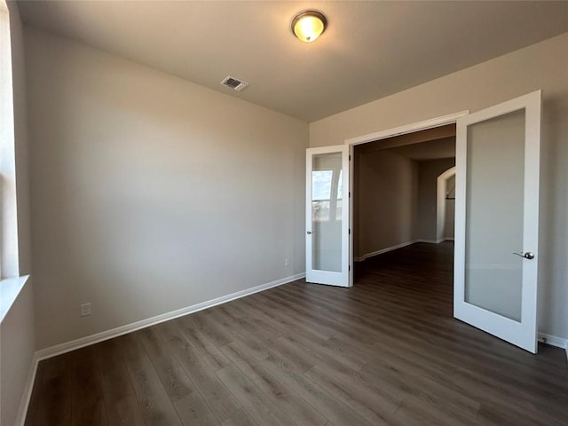 8217 Grenadier Dr, Austin, TX 78738 - spare room with dark wood finished floors, baseboards, and arched walkways