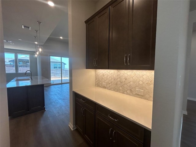 8217 Grenadier Dr, Austin, TX 78738 - kitchen with a sink, dark wood-type flooring, light countertops, backsplash, and vaulted ceiling