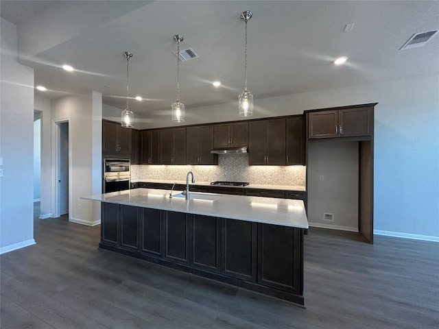 8217 Grenadier Dr, Austin, TX 78738 - kitchen with a sink, baseboards, decorative backsplash, double oven, and under cabinet range hood