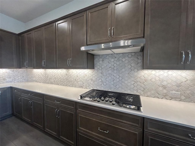 8217 Grenadier Dr, Austin, TX 78738 - kitchen with stainless steel gas cooktop, light countertops, under cabinet range hood, and decorative backsplash