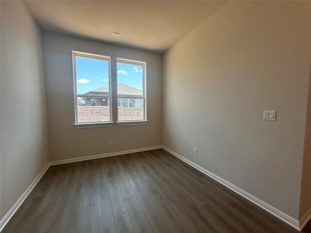 8217 Grenadier Dr, Austin, TX 78738 - spare room featuring dark wood finished floors and baseboards