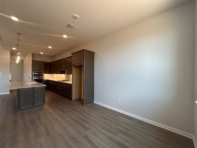 8217 Grenadier Dr, Austin, TX 78738 - kitchen with a sink, baseboards, dark wood finished floors, and recessed lighting