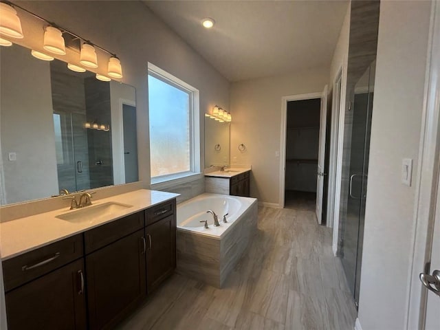 8217 Grenadier Dr, Austin, TX 78738 - bathroom featuring a stall shower, two vanities, and a garden tub