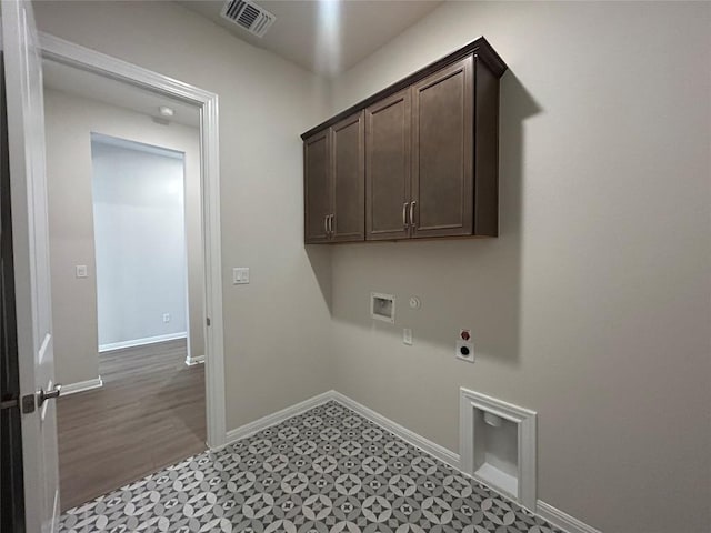 8217 Grenadier Dr, Austin, TX 78738 - laundry area featuring electric dryer hookup, hookup for a washing machine, cabinet space, tile patterned floors, and gas dryer hookup