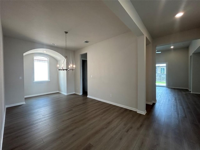 8217 Grenadier Dr, Austin, TX 78738 - empty room featuring a chandelier, dark wood-type flooring, recessed lighting, and arched walkways