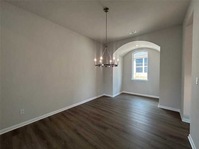 8217 Grenadier Dr, Austin, TX 78738 - unfurnished dining area with dark wood-type flooring, arched walkways, and a chandelier