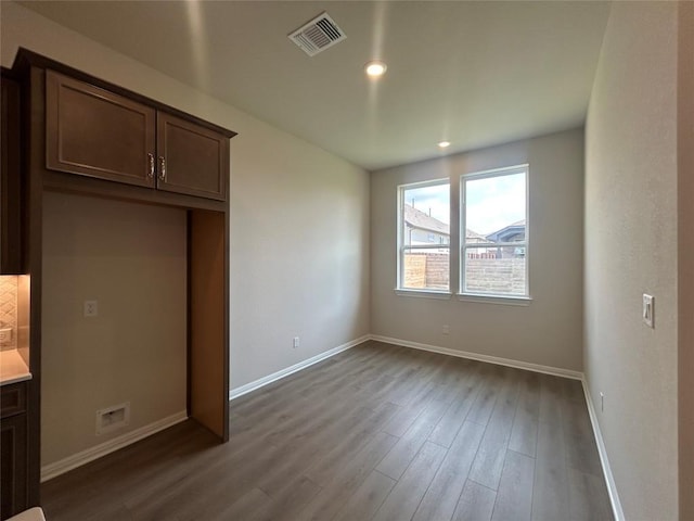 8217 Grenadier Dr, Austin, TX 78738 - unfurnished bedroom with dark wood finished floors and recessed lighting