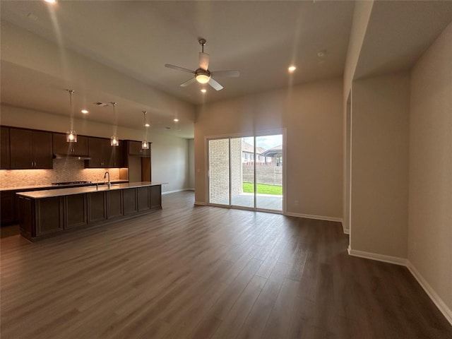 8217 Grenadier Dr, Austin, TX 78738 - unfurnished living room featuring a ceiling fan, dark wood-type flooring, and recessed lighting