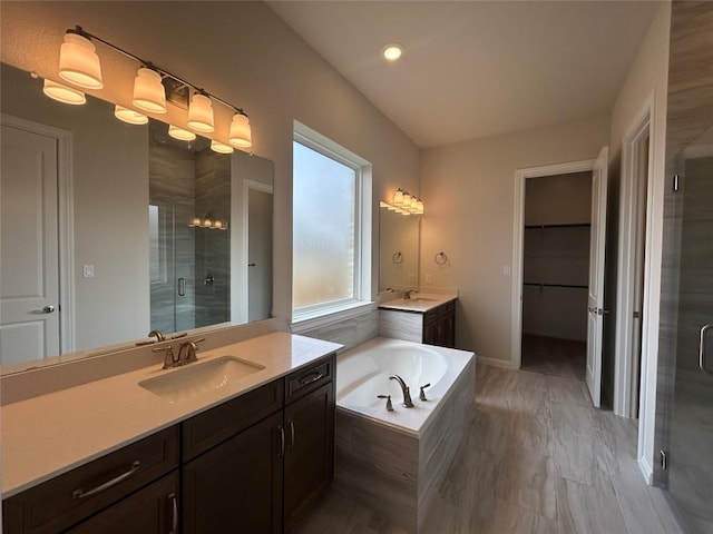 8217 Grenadier Dr, Austin, TX 78738 - bathroom with a shower stall, two vanities, a bath, and a spacious closet