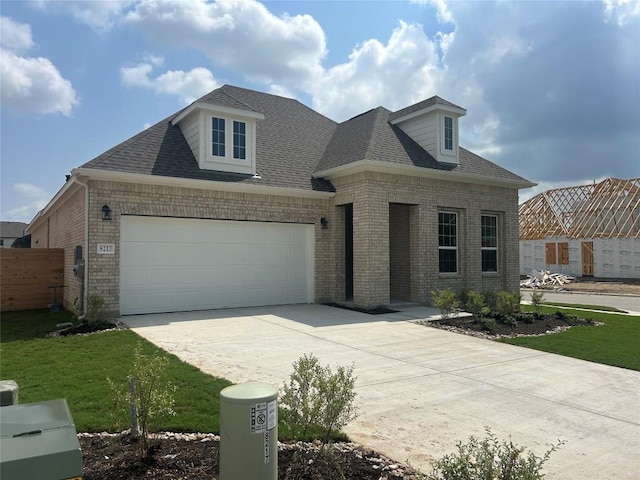 8217 Grenadier Dr, Austin, TX 78738 - french provincial home featuring brick siding, concrete driveway, and a shingled roof