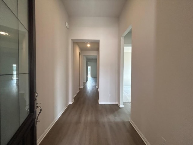 8217 Grenadier Dr, Austin, TX 78738 - hallway featuring dark wood-style flooring and baseboards
