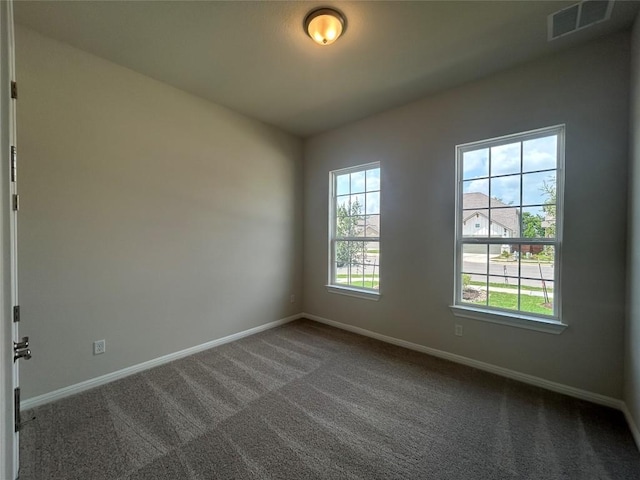8217 Grenadier Dr, Austin, TX 78738 - spare room featuring baseboards and dark colored carpet