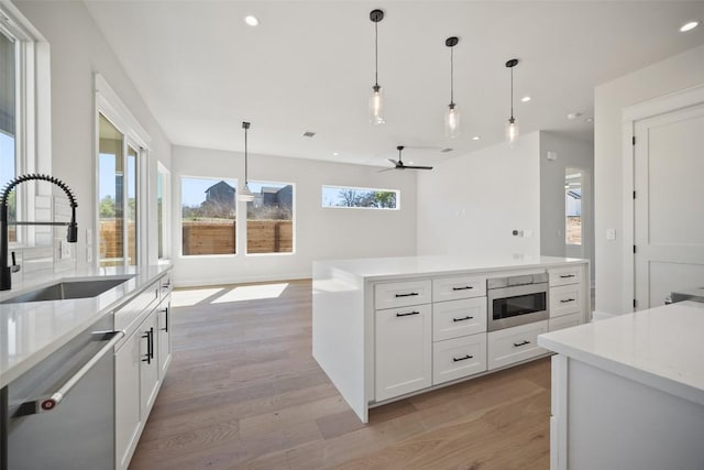 6301 Bristol Cir Unit 1, Austin, TX 78723 - kitchen featuring stainless steel appliances, a sink, recessed lighting, light wood-style flooring, and ceiling fan