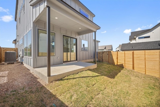 6301 Bristol Cir Unit 1, Austin, TX 78723 - rear view of property featuring board and batten siding, a patio area, and central AC