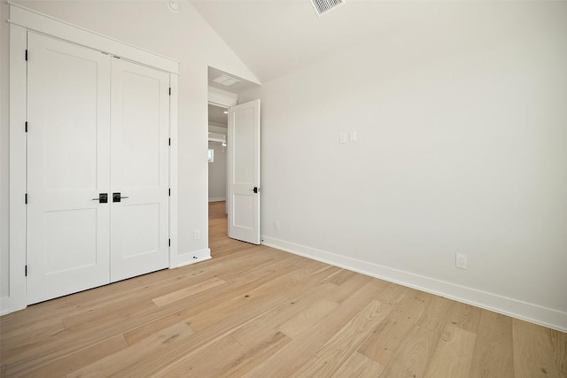 6301 Bristol Cir Unit 1, Austin, TX 78723 - unfurnished bedroom with baseboards, light wood-type flooring, lofted ceiling, and a closet
