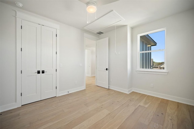 6301 Bristol Cir Unit 1, Austin, TX 78723 - unfurnished bedroom with attic access, light wood-style floors, baseboards, and a closet