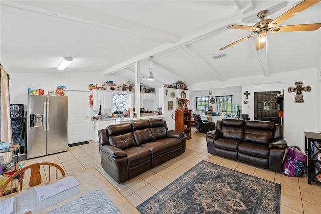 living area with a ceiling fan, light tile patterned floors, and vaulted ceiling with beams