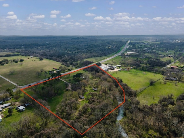 birds eye view of property with a rural view