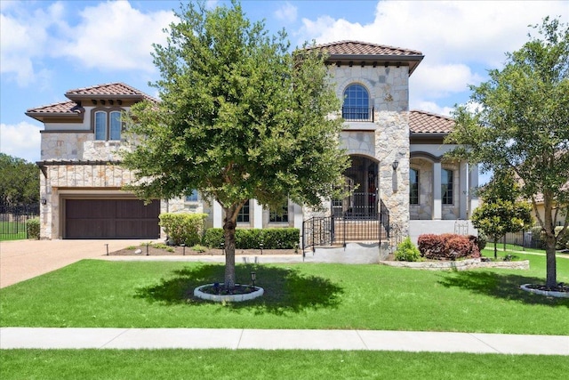 1600 Morning Moon Cir, Austin, TX 78732 - mediterranean / spanish-style house with a tile roof, stone siding, concrete driveway, a front yard, and a garage