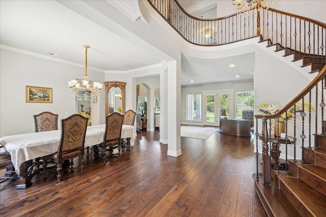 1600 Morning Moon Cir, Austin, TX 78732 - dining area featuring a chandelier, arched walkways, stairway, hardwood / wood-style floors, and ornamental molding