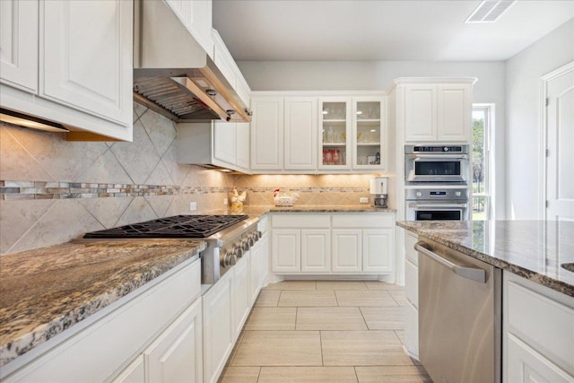 1600 Morning Moon Cir, Austin, TX 78732 - kitchen featuring ventilation hood, appliances with stainless steel finishes, backsplash, white cabinets, and glass insert cabinets