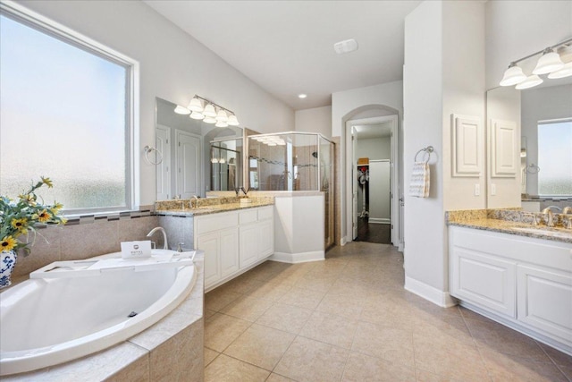 1600 Morning Moon Cir, Austin, TX 78732 - bathroom with a shower stall, a garden tub, two vanities, tile patterned flooring, and a walk in closet