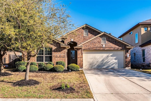 351 Still Hollow Crk, Buda, TX 78610 - view of front of house with brick siding, an attached garage, and concrete driveway