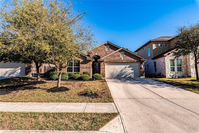 351 Still Hollow Crk, Buda, TX 78610 - traditional-style house with a garage, concrete driveway, brick siding, and a front lawn