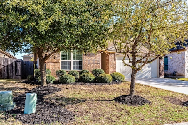 351 Still Hollow Crk, Buda, TX 78610 - obstructed view of property featuring concrete driveway, brick siding, and an attached garage