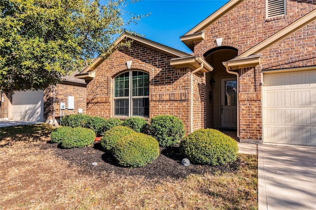351 Still Hollow Crk, Buda, TX 78610 - view of front of property featuring brick siding, a garage, and concrete driveway