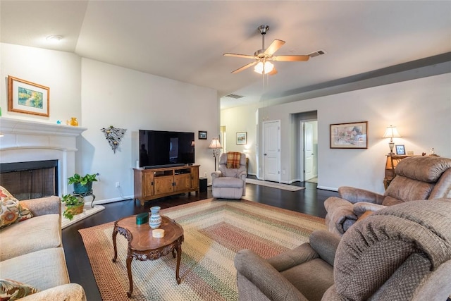 351 Still Hollow Crk, Buda, TX 78610 - living room featuring wood finished floors, a ceiling fan, a fireplace, and baseboards