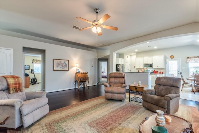 351 Still Hollow Crk, Buda, TX 78610 - living area with wood finished floors, vaulted ceiling, a ceiling fan, arched walkways, and recessed lighting